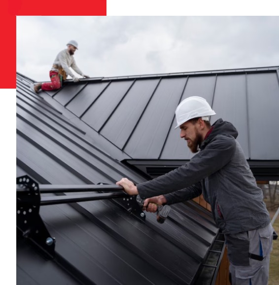 a man working on metallic roof