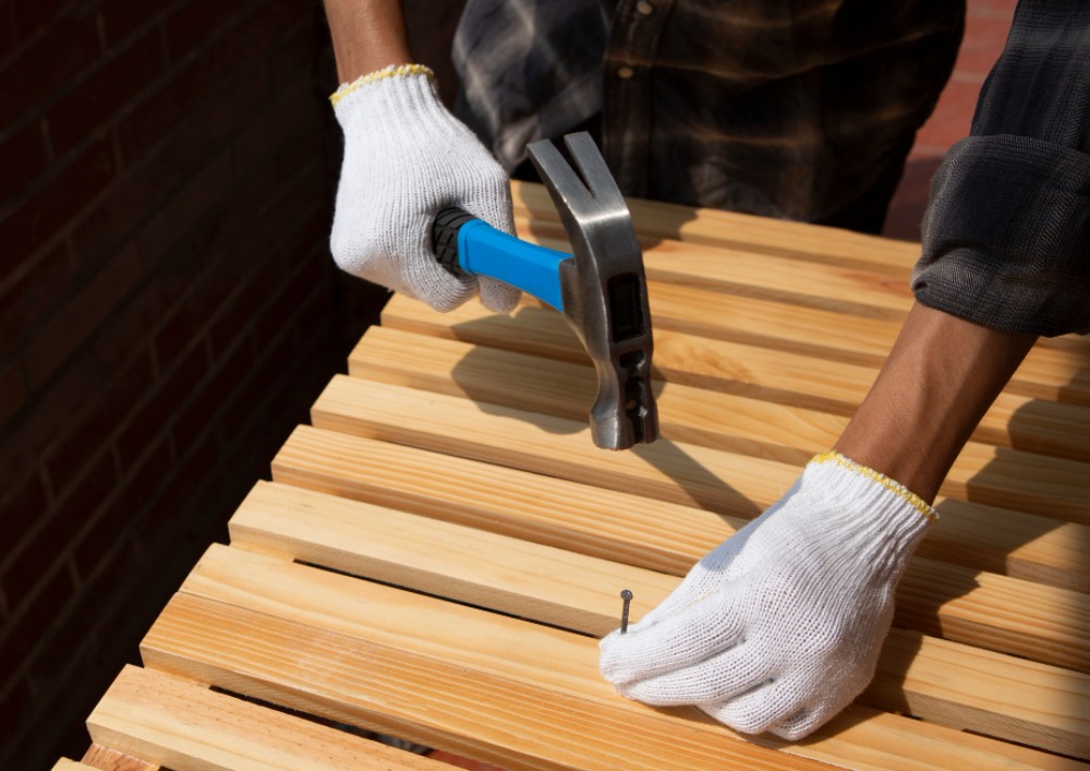 a person hammering a nail