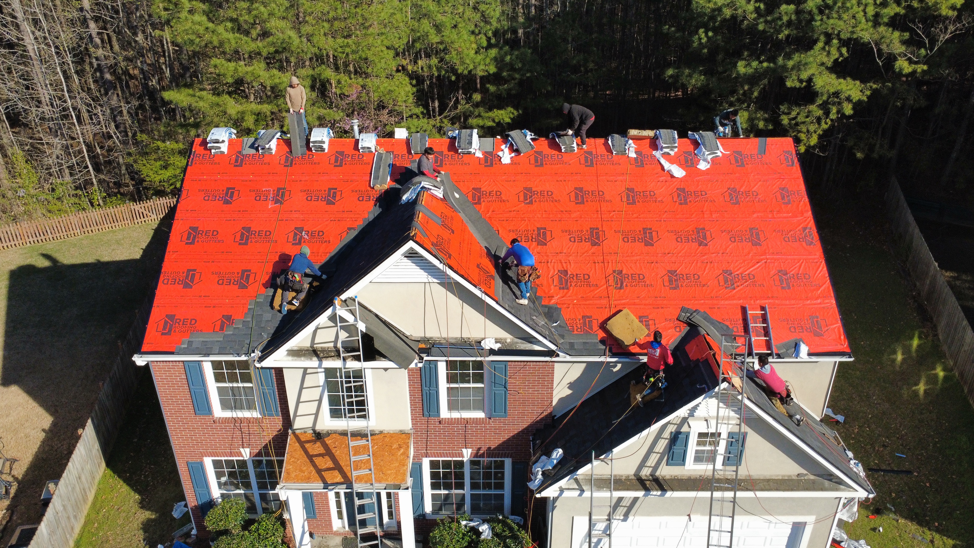 Roof Repairs Atlanta, GA 2 Atlanta roof repair technician checking shingles and flashing on a home
