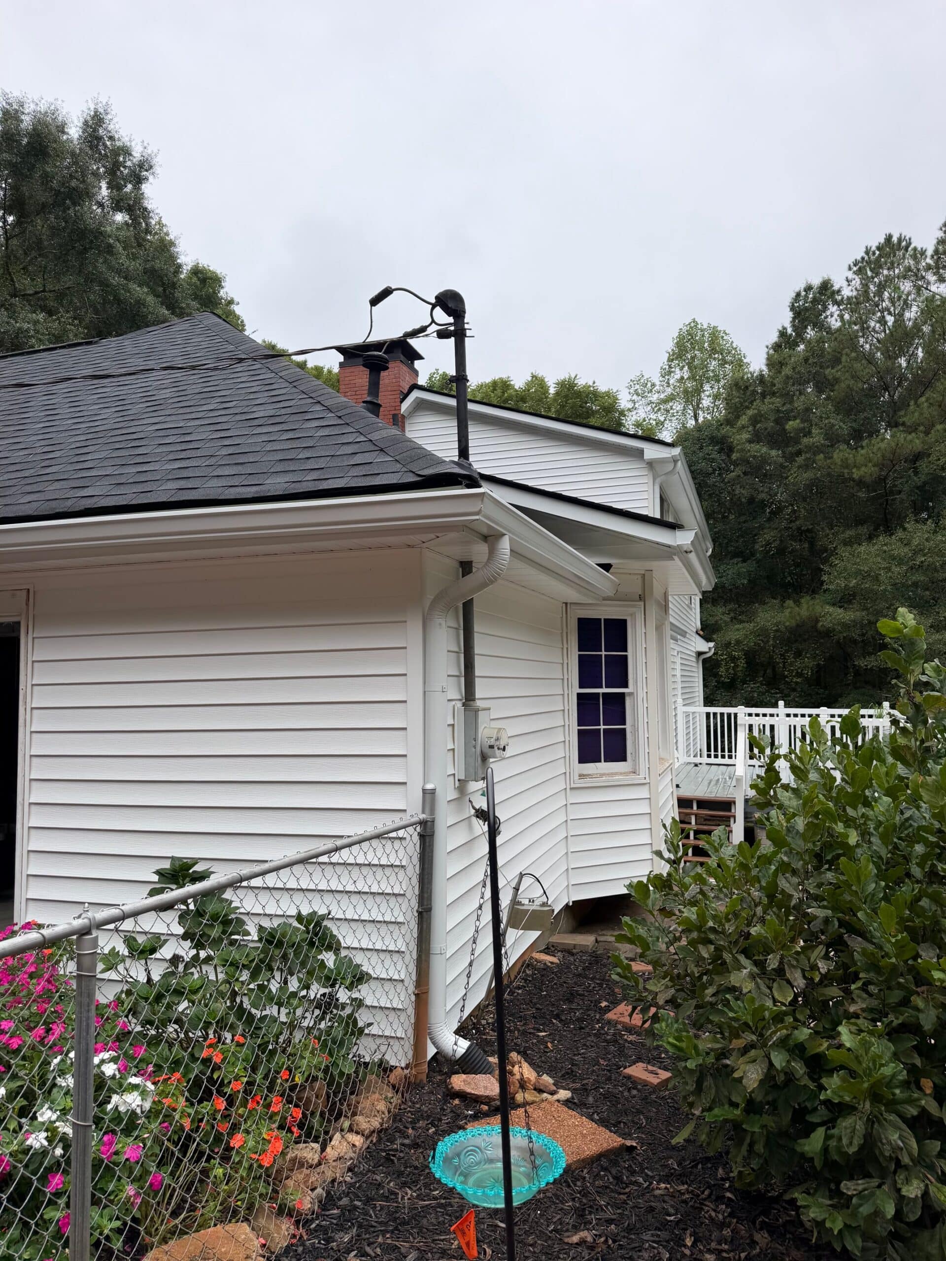 Siding 2 Vinyl siding Madison GA: new white lap siding beside a garage, installed by Red Roofing & Gutters